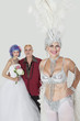 Photo: Portrait of senior showgirl with father and daughter in wedding dress against gray background Portrait of senior showgirl with father and daughter in wedding dress against gray background