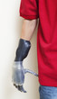 Photo: Cropped image of man with prosthetic hand over gray background Cropped image of man with prosthetic hand over gray background
