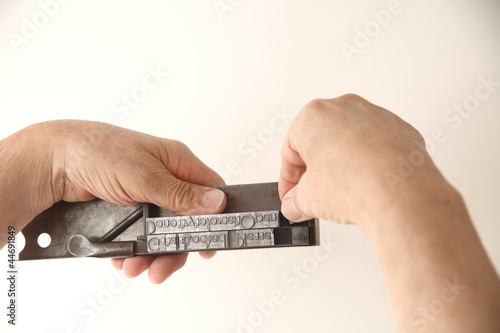 Photo: using composing stick to set type using composing stick to set type