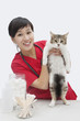 Photo: Portrait of an Asian female veterinarian holding cat against gray background Portrait of an Asian female veterinarian holding cat against gray background