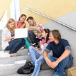 Photo: Students enjoying break on school steps laptop Students enjoying break on school steps laptop