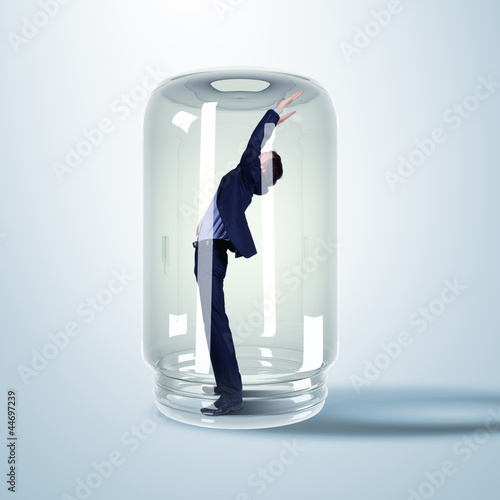Photo: Businessman inside glass jar Businessman inside glass jar
