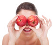 young woman holding apples as binoculars