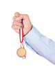Businessman holding blank gold medal isolated on white
