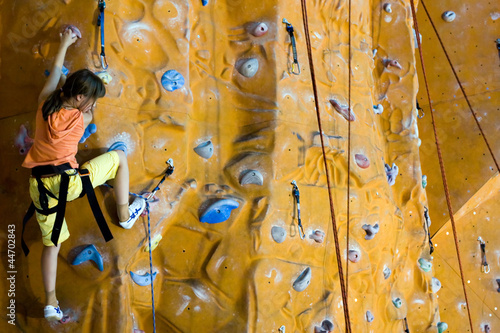 Photo: Climbing teenager girl to the top of wall Climbing teenager girl to the top of wall
