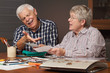 Senior couple choosing photos for album