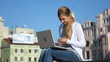 woman with laptop talking on the cellphone