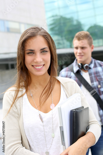 Photo: Portrait of student girl walking on university campus Portrait of student girl walking on university campus