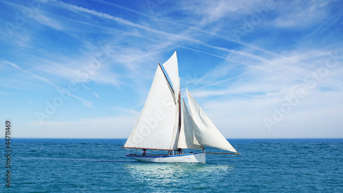 Photo: Seascape with sailboat the background of the blue sky. Seascape with sailboat the background of the blue sky.