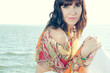 Horizontal shot of a young caucasian woman relaxing on the shore