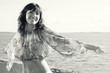 Young woman relaxing on the shore, black and white image