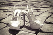 White mules on the cobble-stone pavement