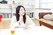 a young asian woman studying in the room