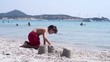 Child building sand castle