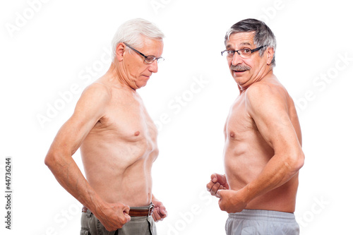Photo: Two seniors comparing figure Two seniors comparing figure