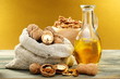 Walnut oil in bottle and nuts.