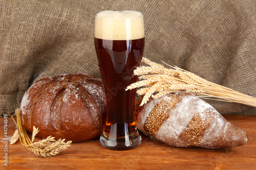 Photo: glass of kvass with bread on canvas background close-up glass of kvass with bread on canvas background close-up