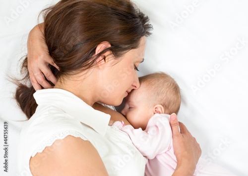 Photo: happy mother breast feeding her baby infant happy mother breast feeding her baby infant