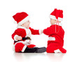 two funny small kids in Santa Claus clothes isolated on white ba