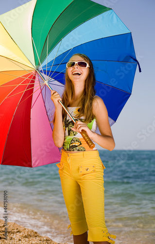 Photo: Teenage girl carrying iridescent umbrella Teenage girl carrying iridescent umbrella