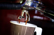 Photo: fresh coffee from machine brewing to paper cup of hot coffee fresh coffee from machine brewing to paper cup of hot coffee