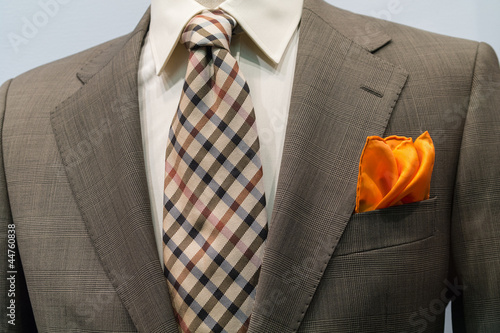 Photo: Light grey checkered jacket with brown checkered tie and orange Light grey checkered jacket with brown checkered tie and orange
