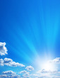 Amazingly blue sky, sun and gentle clouds