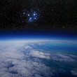 High altitude view of the Earth in space and the Pleiades.