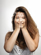 Very happy smiling or laughing (through hands) young beautiful w