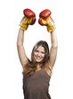 Attractive young woman wearing boxing gloves