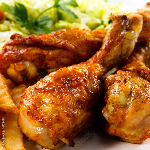 Photo: Grilled chicken legs with chips and vegetables Grilled chicken legs with chips and vegetables