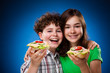 Kids eating big sandwiches