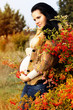 Portrait of beautiful pregnant woman walking in autumn park