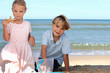 Brother and sister playing on the beach