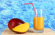 Ripe appetizing mango on woven napkin on water background