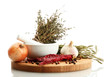 dried herbs in mortar and vegetables, isolatrd on white