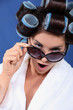 woman with curler wearing bath robe and sunglasses
