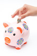 woman hand euro piggybank