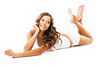 Beautiful woman in cotton underwear is lying on white
