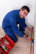 Photo: Man measuring copper tube Man measuring copper tube