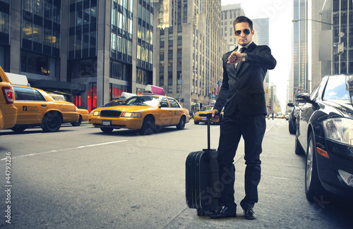 Photo: Businessman looking at his watch in New York Businessman looking at his watch in New York