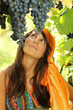 Beautiful girl looking at grapes