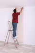 craftsman putting wallpaper