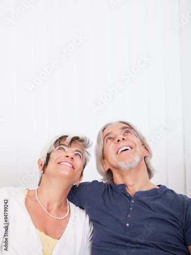 Photo: Loving senior couple daydreaming Loving senior couple daydreaming