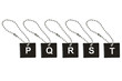 Black metal key tag with letter P-T