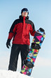 Happy sportswoman with snowboard