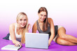 Friendship fun, two pretty girls on laptop
