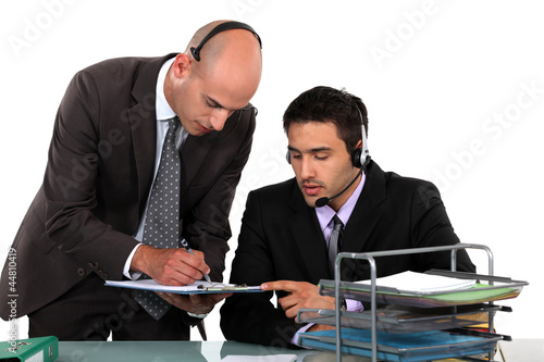 Photo: Office workers wearing headsets Office workers wearing headsets