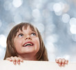 little girl with board with empty space - bokeh background