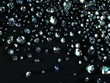 a variety of diamonds scattered on black surface